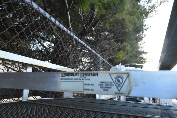 2 metal commercial pan transport racks on casters. Servolift Eastern branded, fabricated food service equipment.