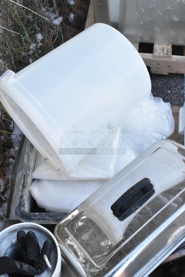 Assorted items including white poly bins and a stainless steel chafer lid; 11-piece auction lot, outdoor setting.
