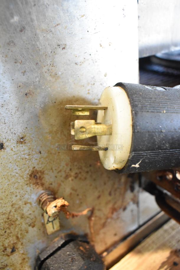 Close-up of an electrical plug showcasing a Middleby Marshall CTX DZ33I conveyor pizza oven's stainless steel body.