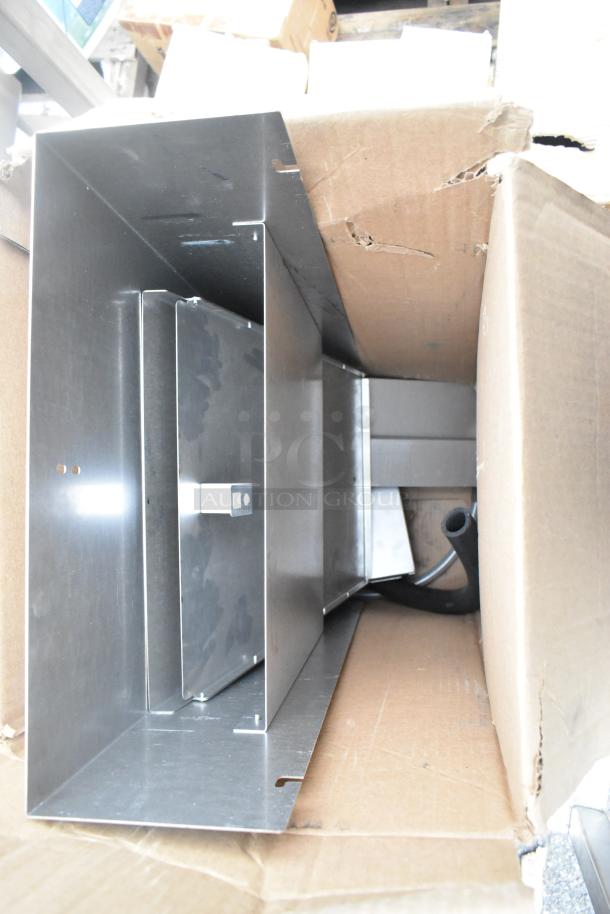 Brand new Cleveland ES26304433G equipment stand in original packaging, slight dents visible on stainless steel surface, boxed.