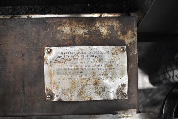 Blodgett stainless steel commercial gas pizza oven detail, showing a plaque with operational instructions.