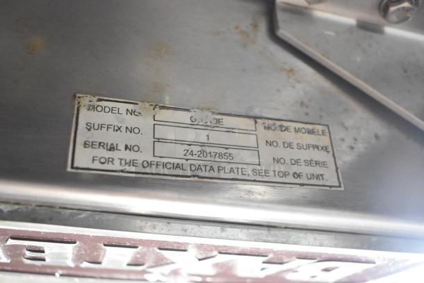 Baxter OV310E oven data plate showing model, suffix, and serial number Z4-2017855, on stainless steel surface.