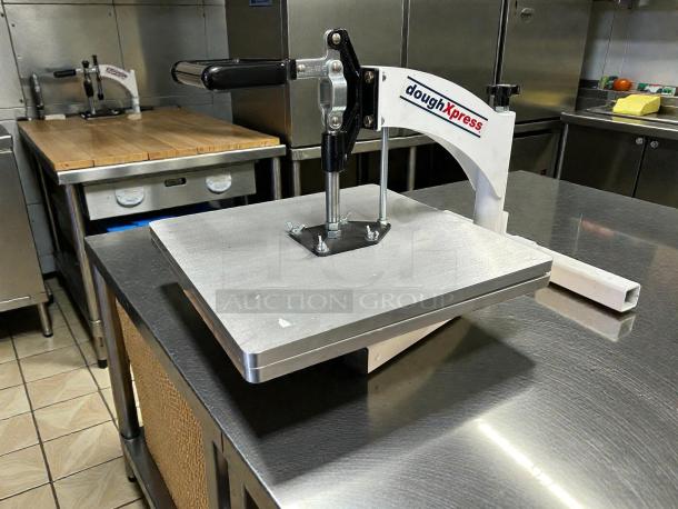 DoughXpress TXM-15CP manual meat press in great condition, stainless steel, tested and working, features brand logo.