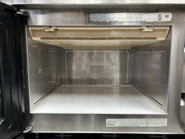 Sharp R22GTF stainless steel commercial microwave interior. Touch controls, 20 programmable settings. Tested, working. Model label visible.
