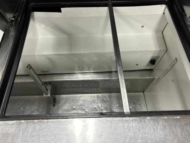 True TSSU-60-24M-B-ST-HC prep table interior, excellent condition, stainless steel, inspected.