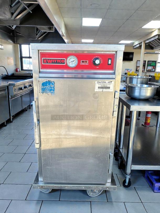 Wittco 1826-5 heated holding cabinet, mobile half-height, stainless steel, tested, red controls, "Caution: Hot" label.
