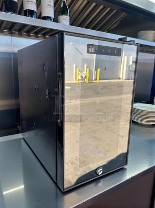 Black countertop refrigerator in like-new condition, featuring a digital display, plug-in power, and included keys.