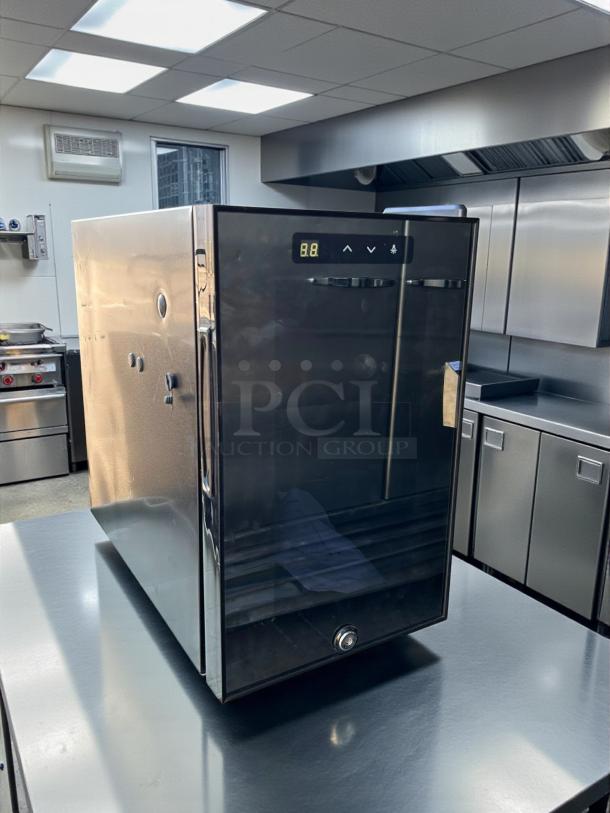 Like new countertop black refrigerator with digital display, plug-in, and keys. Sleek design, amazing condition.