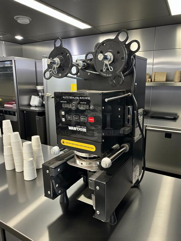 WantJoin WZ-95B Cup Sealing Machine, 110-120V, tested and working. Features digital display, sturdy frame, and safety labels.