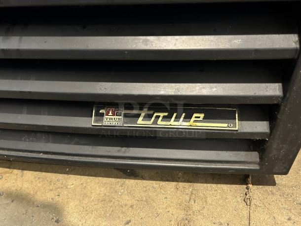 True GDM-23-HC~TSL01 merchandiser, black, right hinge glass door, 27", 115v, excellent condition, True logo visible.