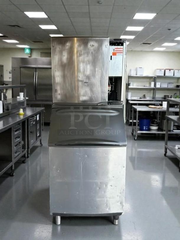 Manitowoc SY0854A air-cooled ice maker in excellent condition, stainless steel exterior, tested and working, commercial kitchen setting.