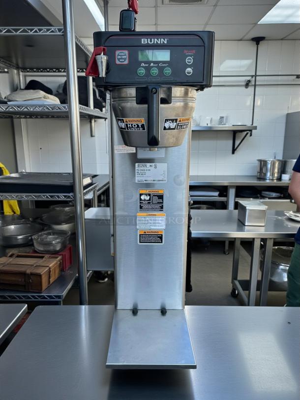 Bunn 53100.0000 ICB-DV coffee brewer in excellent condition. Dual voltage, stainless steel, tested and working, with visible safety labels.