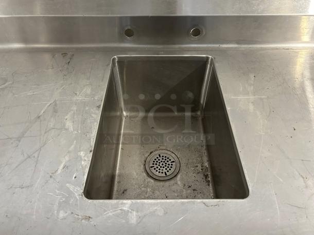 Winholt stainless steel worktop table with integrated hand sink and backsplash. Excellent condition, minimal wear, durable finish.