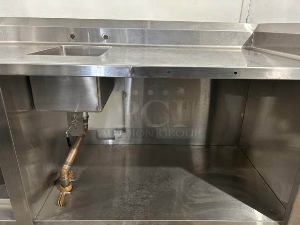 Winholt stainless steel worktop table with hand sink and backsplash in excellent condition. Features durable construction and plumbing.