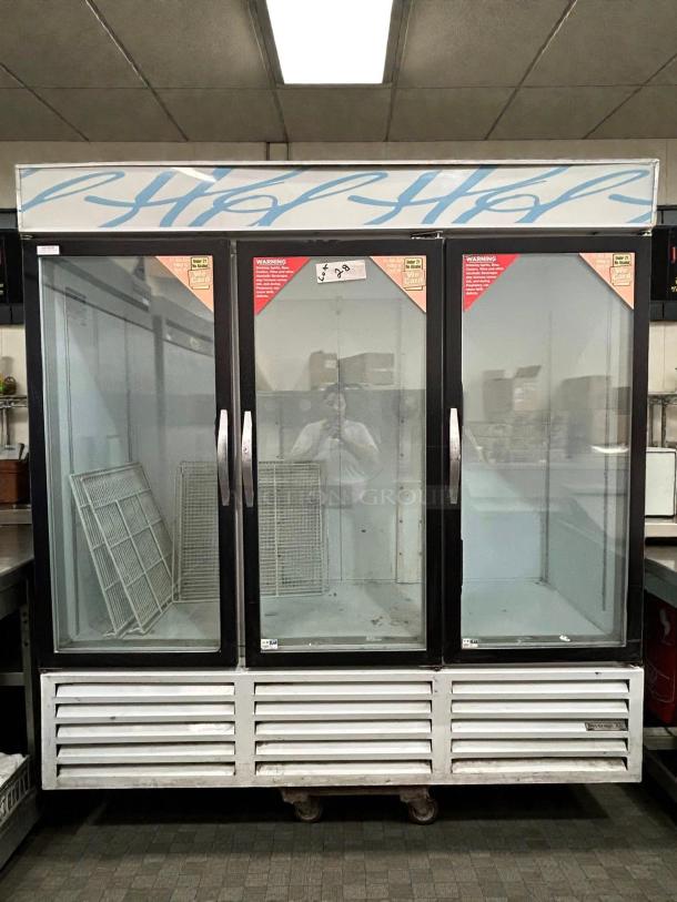 Beverage Air CRG74-1 three-door refrigerator, self-contained, tested, and working. Features glass doors and interior shelves.