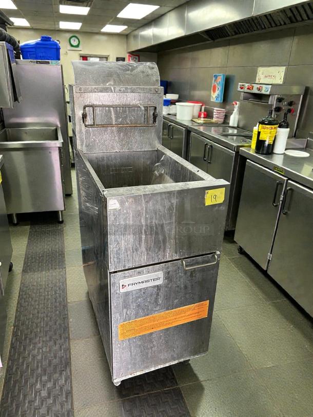 Frymaster ESG35T 35lb stainless steel gas fryer in a commercial kitchen; tested, working, with visible brand label and warnings.