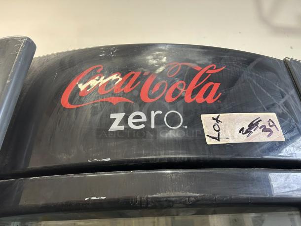 True GDM-26-HC~TSL01 glass door merchandiser, Coca-Cola Zero branding, pre-owned, tested working, lot label visible.