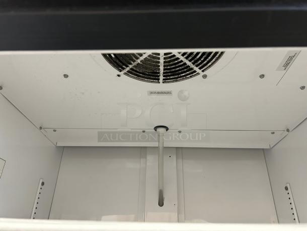 True GDM-26-HC~TSL01 30" refrigerated merchandiser interior, clean condition, visible fan and shelving pegs.