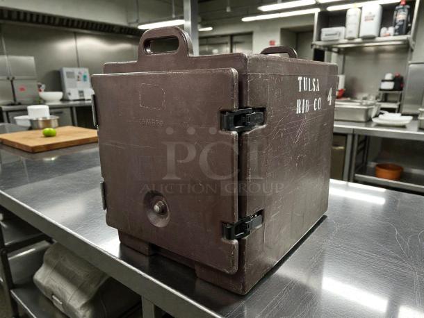 Cambro Camcarrier UPC400110, brown, holds 4 full-size pans, excellent condition, with secure latches in a commercial kitchen.