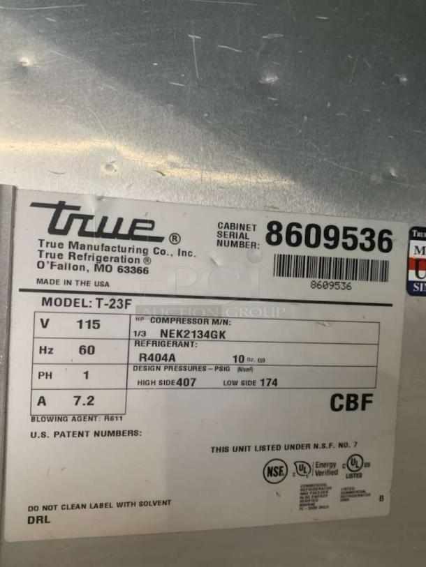 Alt text: True T-23F commercial freezer label, model details, 115V, refrigerant R404A, NSF and UL certifications, serial number 8609536.