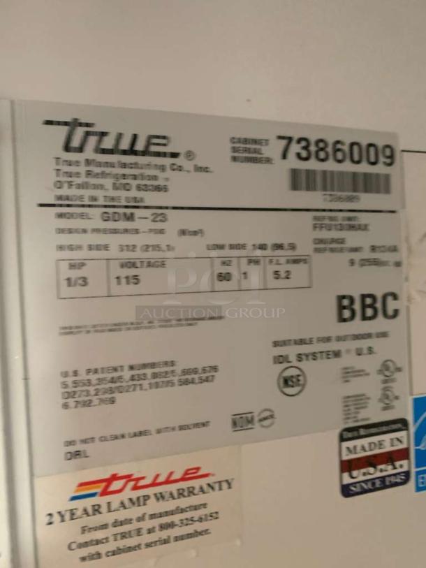 True GDM-23 commercial refrigerator label with model details and serial number. Made in USA, 115V, 2-year lamp warranty.