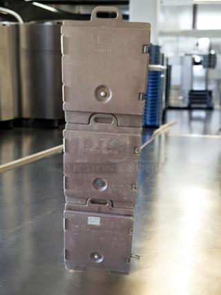Stack of three Cambro UPC insulated food transport carriers in prime condition, brown with secure latches, fully tested.