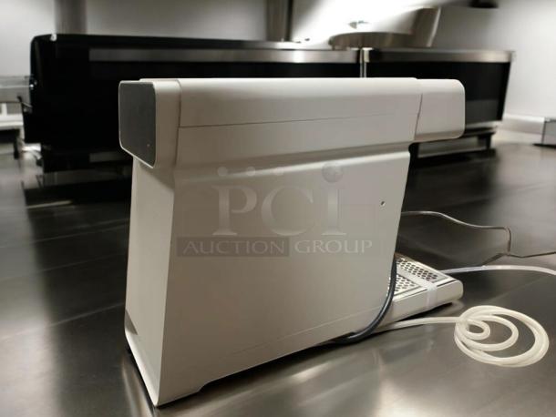 Commercial countertop hot/cold beverage dispenser in great condition, showing side view with power and dispensing cords.