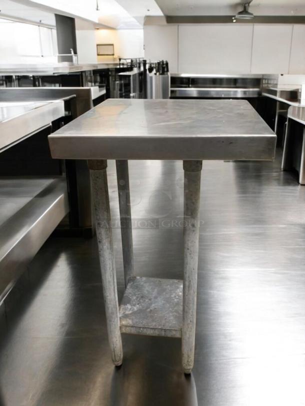 Heavy-duty stainless steel prep stand in great condition, commercial-grade, tested and ready. Features sturdy legs and lower shelf.