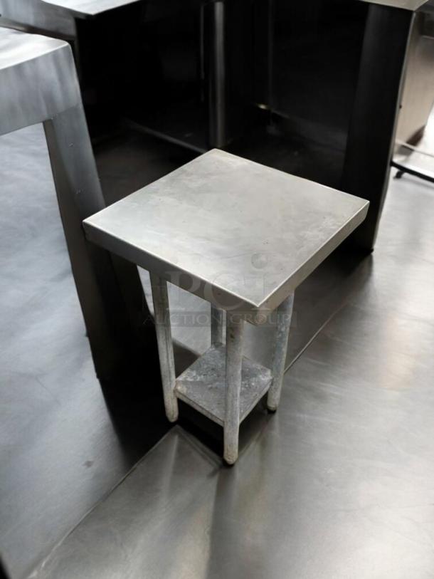 Heavy-duty stainless steel prep stand, great condition, square top, sturdy build, tested, ideal for commercial use.