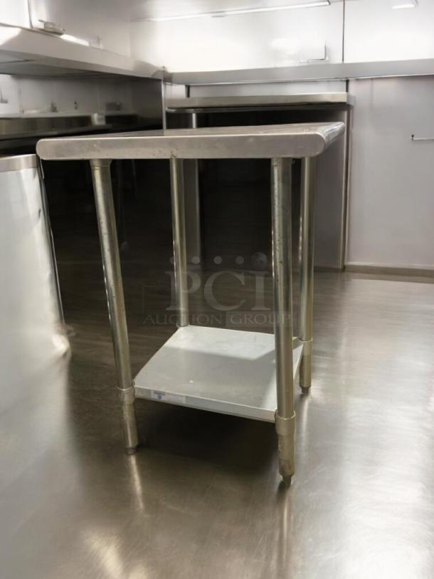 Prime condition stainless steel prep stand, heavy-duty model, fully tested. Features reinforced legs and smooth top surface.