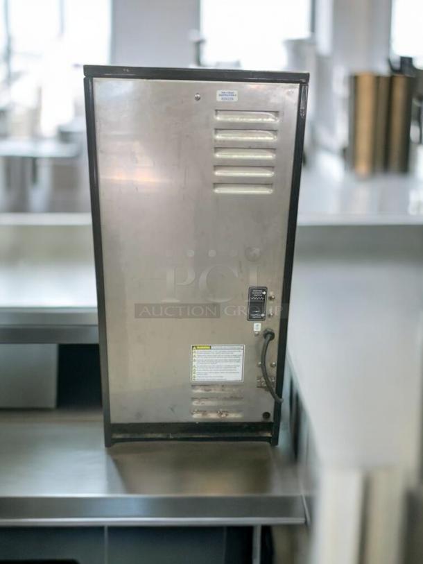 Pristine Curtis PC-4D-10-80 beverage dispenser, stainless steel finish, rear view, visible power cord, warning label.