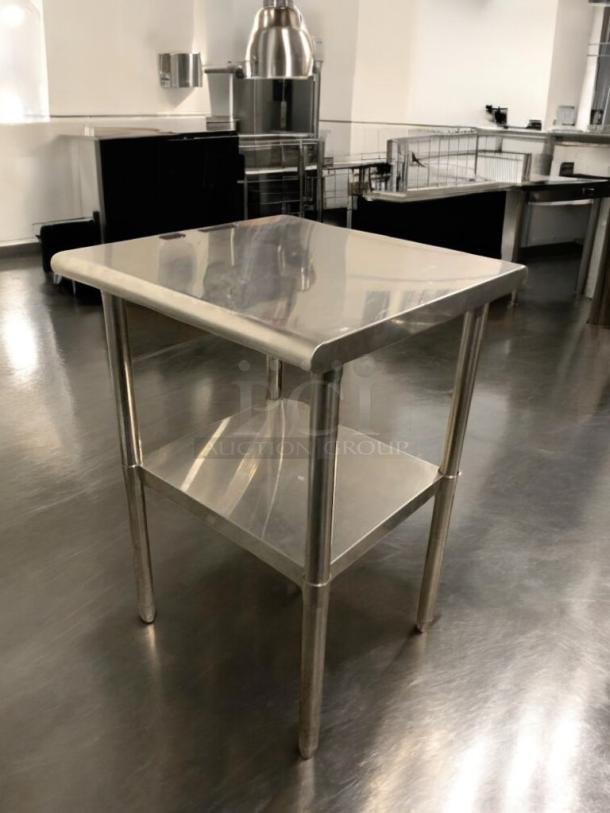 Pristine stainless steel prep table, heavy-duty commercial make, with lower shelf; fully tested, ready for use.
