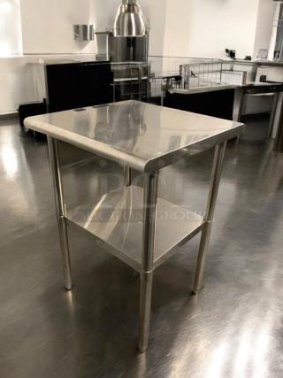 Pristine stainless steel prep table, heavy-duty commercial make, with lower shelf; fully tested, ready for use.