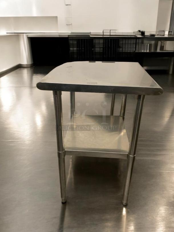 Pristine stainless steel prep table, heavy-duty commercial make, two-tier design, excellent condition, tested and ready.