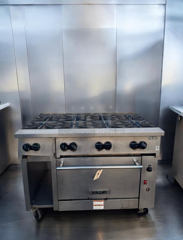 Vulcan 48C-8BN 8-burner gas range with standard oven, excellent condition; features Vulcan logo and control knobs.