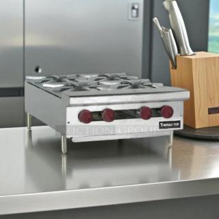 Brand new Therma-Tek TCHP24-4 24" gas hotplate, factory sealed, featuring 4 burners and controls, stainless steel finish.