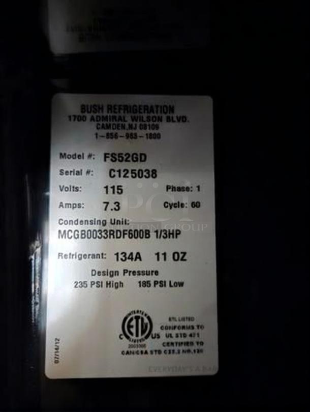 Label for Bush Refrigeration FS52GD merchandiser showing model, serial number, voltage, and refrigerant details.