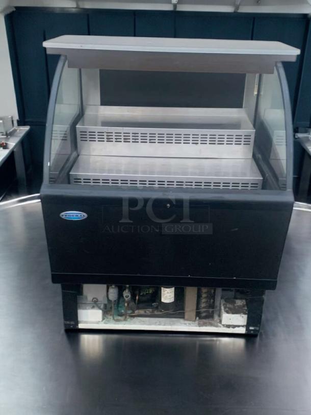 Federal Industries refrigerated curved-glass display case in immaculate condition; fully tested and working, black exterior.