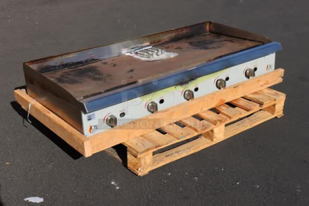 Cooking Performance Group GM-CPG-60-NL 60" gas griddle, manual controls, 150,000 BTU, mild surface rust, on wooden pallet.