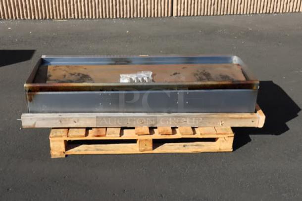 Cooking Performance Group GM-CPG-60-NL 60" gas countertop griddle, 150,000 BTU, mild surface rust, on wood pallet.