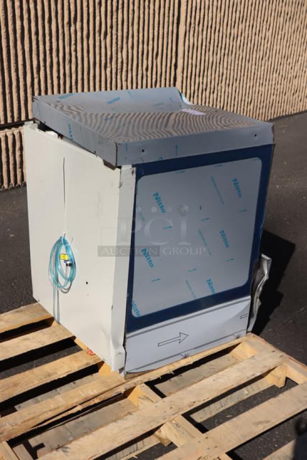 Brand new Noble Warewashing HT-UC24 undercounter dishwasher with booster heater, minor scratches, model details visible, on pallet.