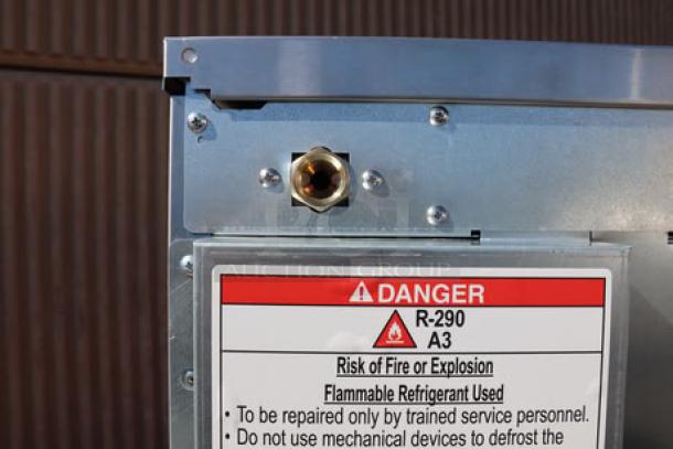 Hoshizaki C-80BAK-AD ice machine corner view with caution label about flammable refrigerant. Out of packaging.