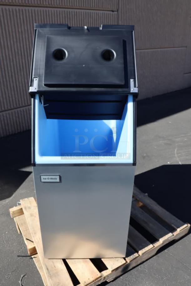 Brand new Ice-O-Matic B42PSC ice storage bin, 351 lb capacity, out of packaging, minor dents and scratches visible.