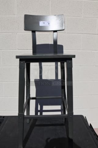 Bar height wood stool with back and footrest, brand new scratch-n-dent condition. Auction tag visible on backrest.