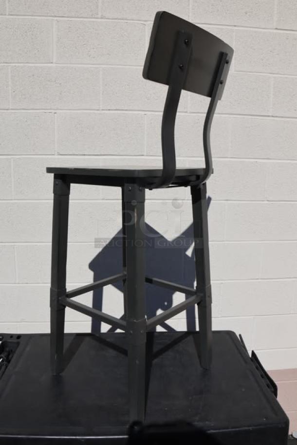 Bar height wood stool with backrest and footrest, scratch-and-dent condition. Features sturdy dark wood frame.