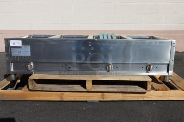 BRAND NEW ServIt EST-4WS four pan sealed well electric steam table, 120V, 2000W. Minor scratches and dents, adjustable undershelf.