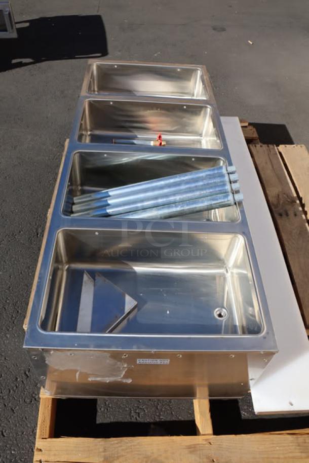 BRAND NEW ServIt EST-4WS four pan electric steam table, 120V, 2000W. Out of packaging, minor scratches and dents visible.