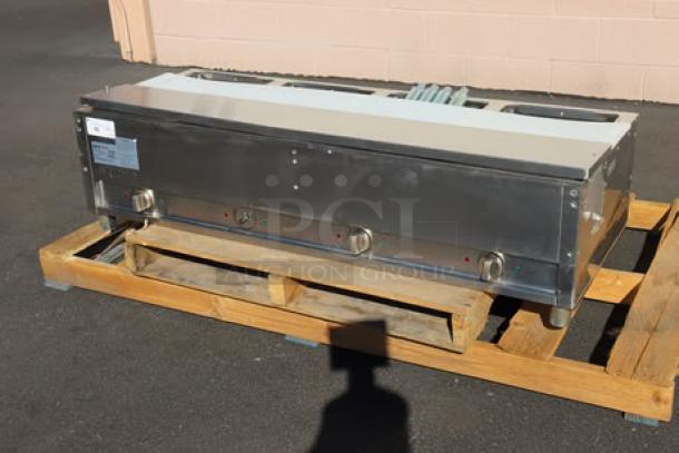 BRAND NEW ServIt EST-4WS four-pan electric steam table, 120V, 2000W. Out of packaging, minor scratches and dents visible.