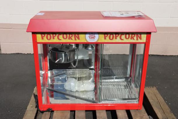 Carnival King PMW17R popcorn machine, new, 8 oz capacity, with warming merchandiser; red exterior, visible packaging inside.