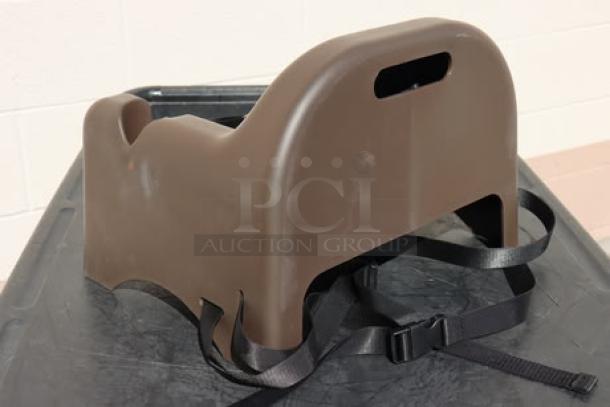 Brand new Carlisle 911401 brown polypropylene booster seat with safety strap, durable and suitable for children.